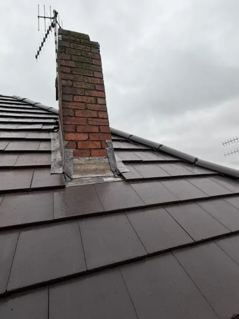 Chimney with new lead flashing on a tiled roof