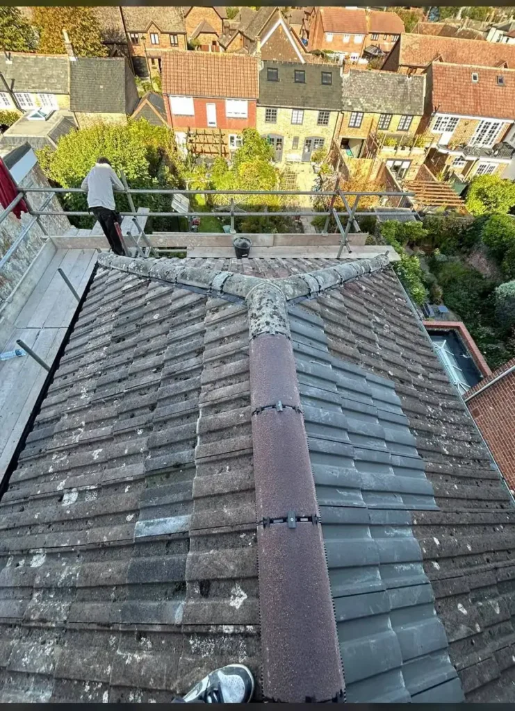 Hip roof with re-bedded hip and ridge tiles