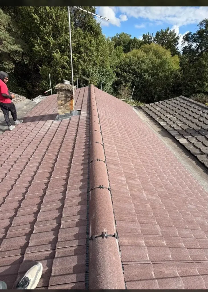 Red tiled roof with new ridge tiles
