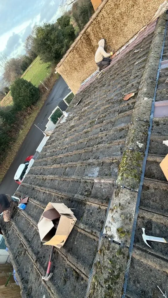 Ridge tiles being replaced on a tiled roof