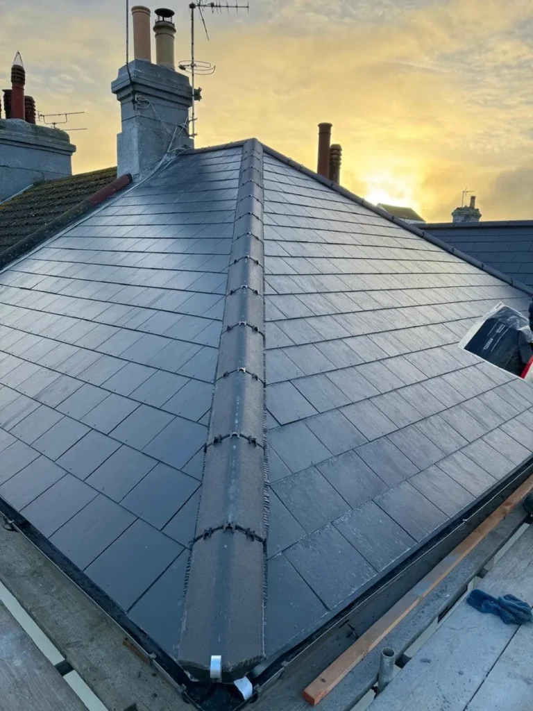 Completed slate hip roof at sunset